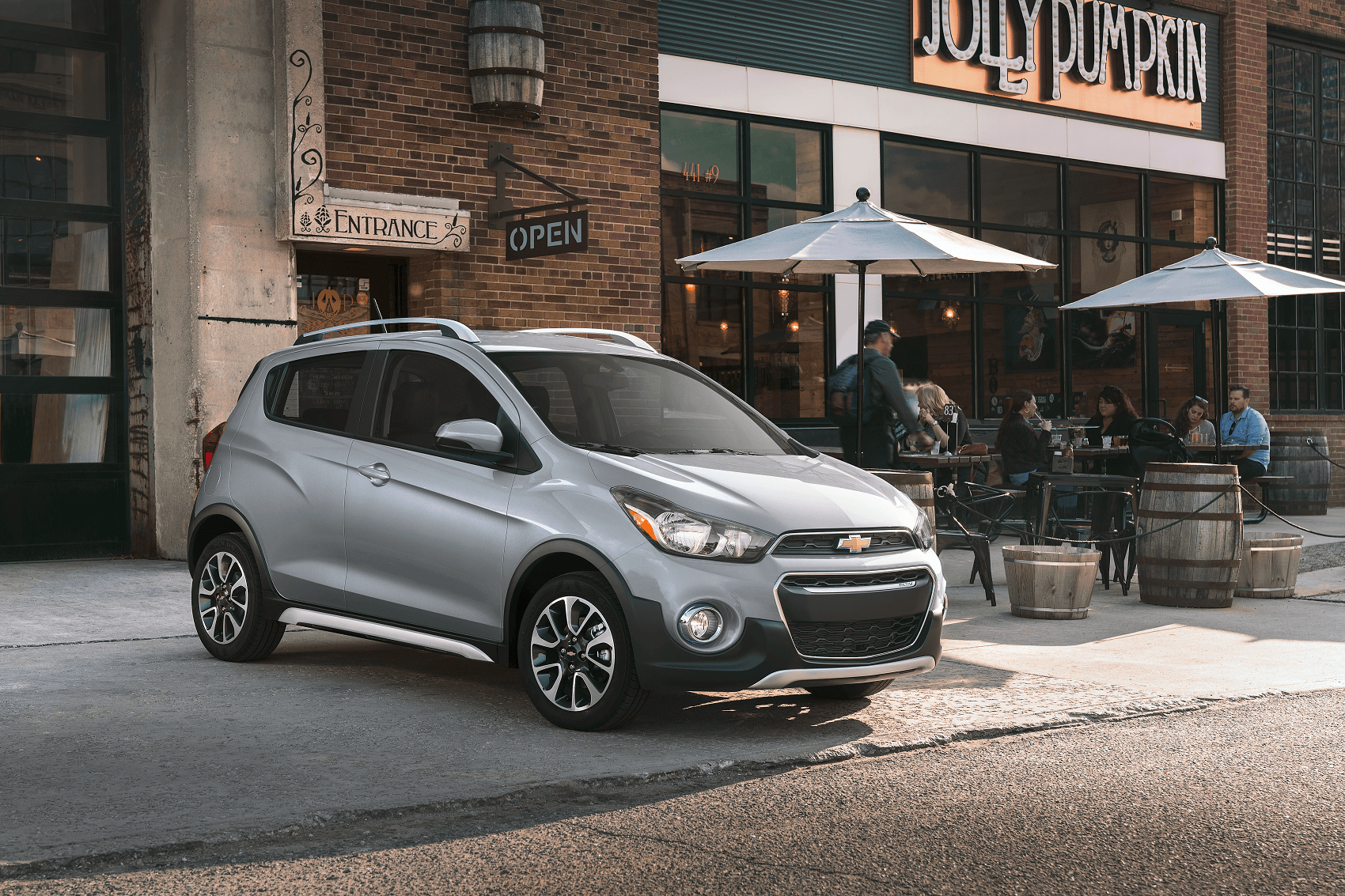 silver chevy trax parked outside a downtown cafe with outdoor dining