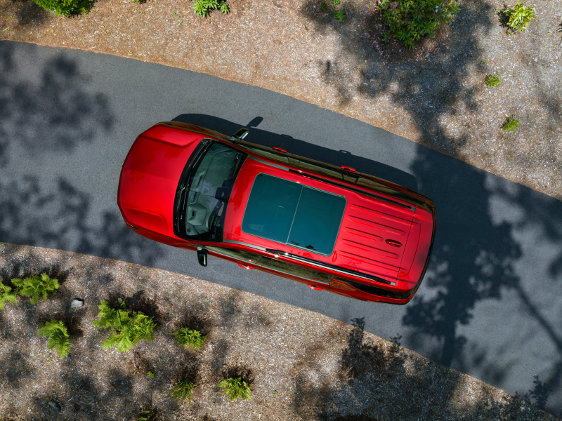 Top view of a red chevy traverse parked on curved driveway